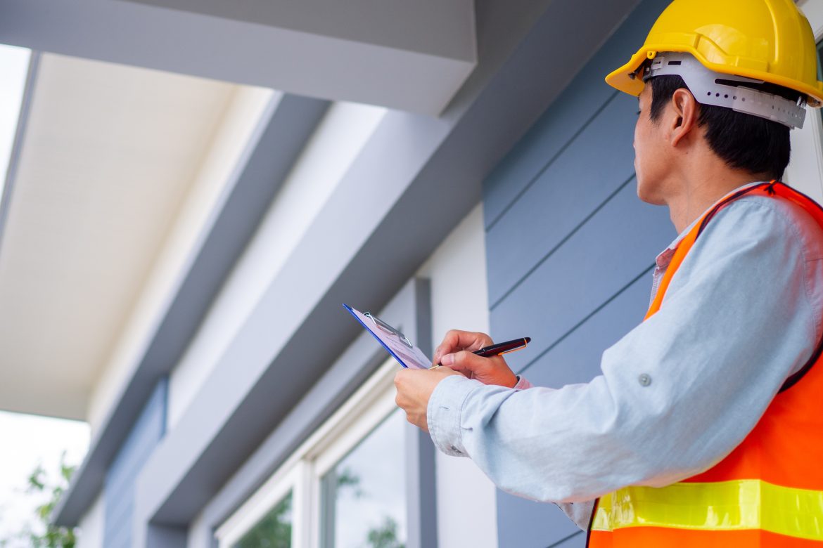 The inspector or engineer is checking the building structure and house roof specifications. After the renovate is complete