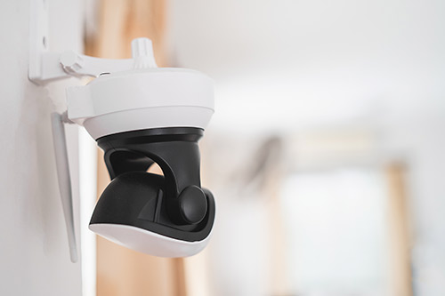 Wall-mounted white and black camera in a newly built home located in Mission, Texas.