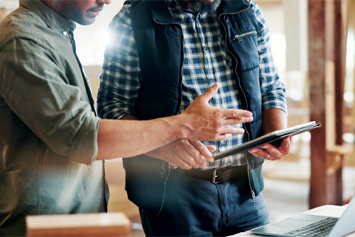 Carpentry, people or hands with tablet in workshop, manufacturing timeline or material cost research. Flare, project planning or men with tech for woodwork schedule, production info or lumber price